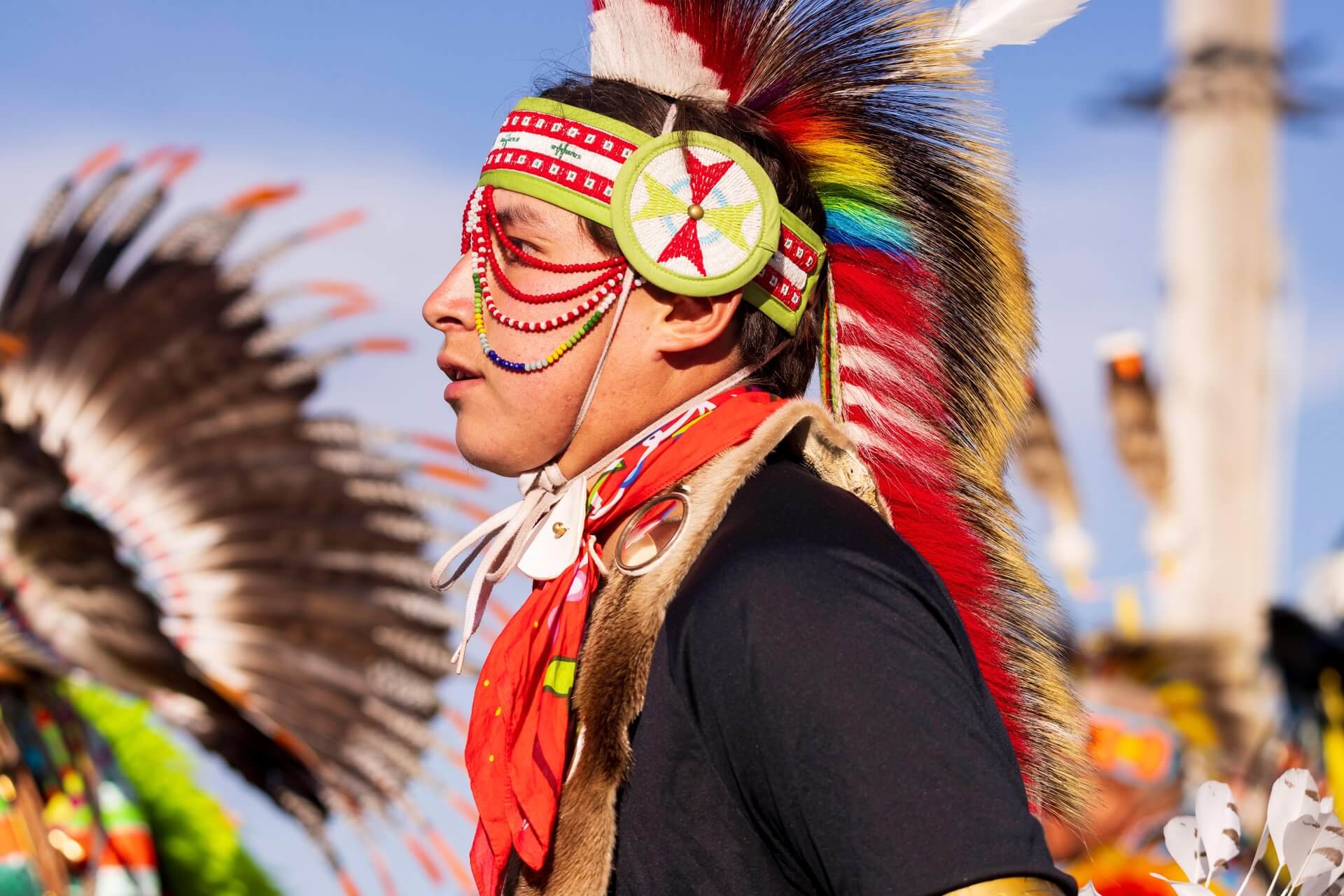Wyoming’s Heritage: Rooted in the Modern American Spirit 4 A close-up of a man wearing a headdress and traditional clothing at the Annual Eastern Shoshone Indian Days Powwow.