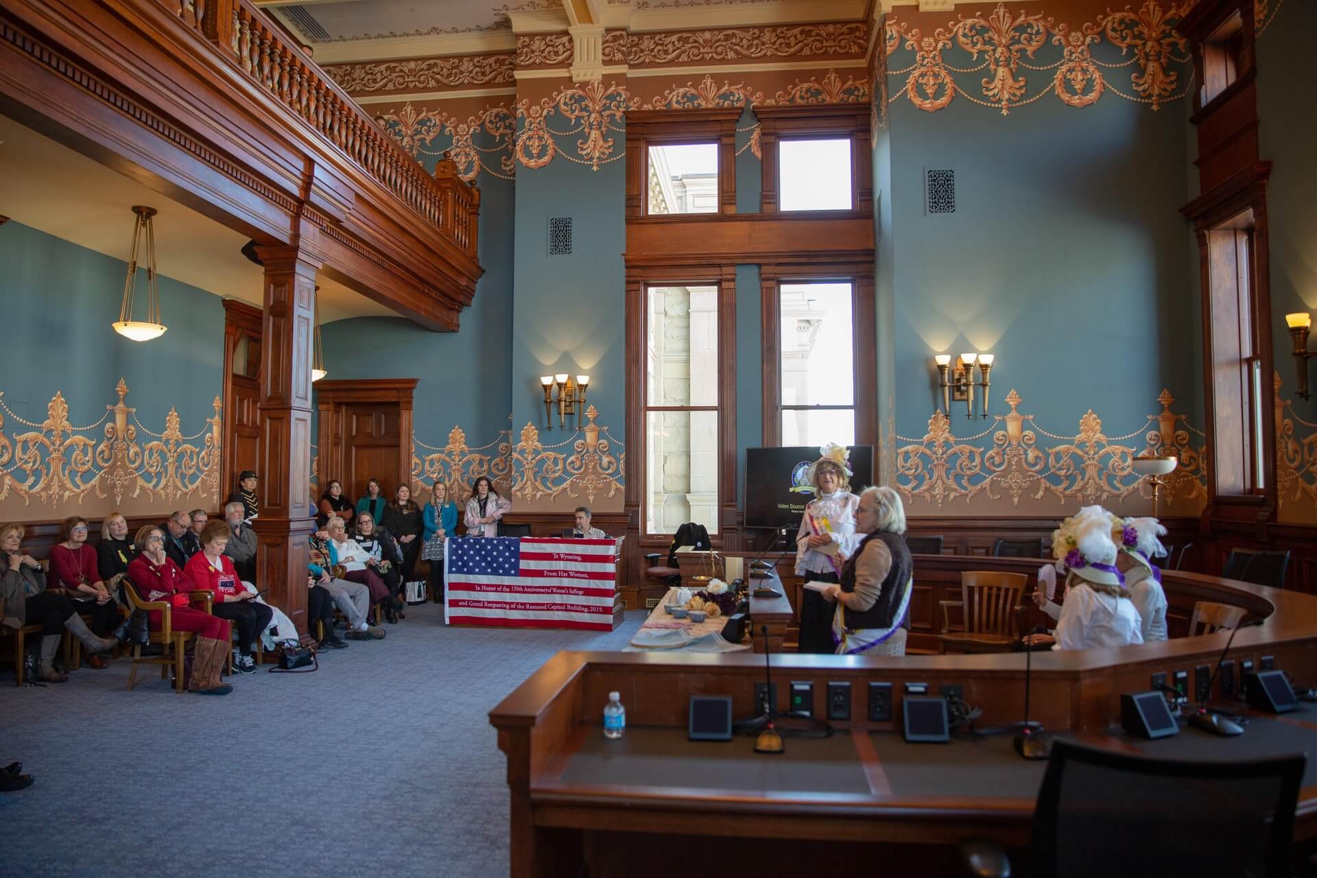 Uncovering Hidden Histories: Lesser-Known Stories from Wyoming’s Early Days 3 Women gathering in historic courtroom setting.